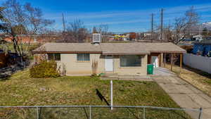 View of front of home featuring a carport, brick siding, a shingled roof, and concrete driveway