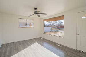 Empty room featuring wood finished floors and ceiling fan