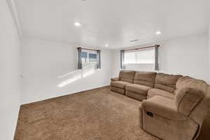 Living area featuring carpet and recessed lighting