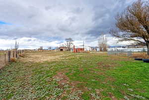 View of yard with an outdoor structure and a view of rural / pastoral area