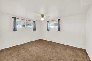 Spare room with carpet flooring and a ceiling fan