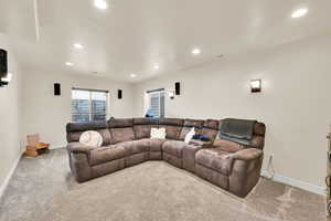 Living room with carpet flooring and recessed lighting