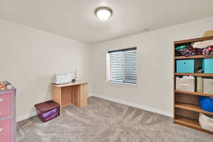 Home office with light carpet and a textured ceiling