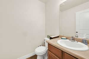 Half bath featuring vanity and toilet