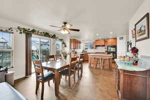 Dining room with recessed lighting, ceiling fan, and light flooring