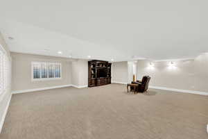 Unfurnished room with light colored carpet and recessed lighting