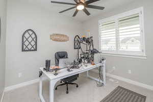Office space featuring light colored carpet and a ceiling fan