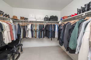 Spacious closet featuring light colored carpet