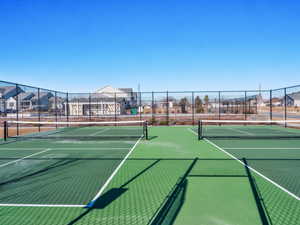 View of tennis court featuring a residential view