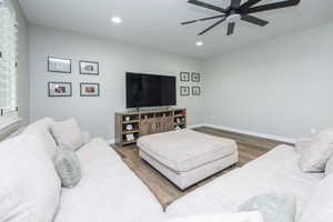 Living area featuring wood finished floors, ceiling fan, and recessed lighting
