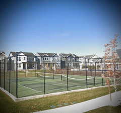 View of tennis court featuring a residential view