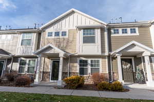 Craftsman-style home with stone siding and board and batten siding