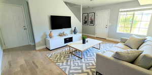 Living room with light wood finished floors and baseboards