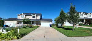 Traditional home featuring a porch, concrete driveway, and a garage