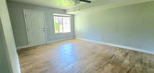 Empty room with wood finished floors and ceiling fan
