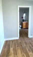 Half bathroom featuring vanity and wood finish floors