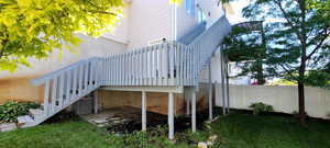 View of side of home featuring stairs and a wooden deck