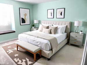 Carpeted bedroom with baseboards