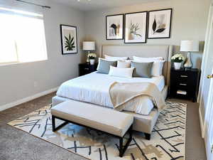 Bedroom featuring baseboards and carpet