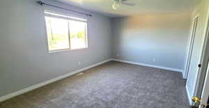 Spare room with carpet and ceiling fan