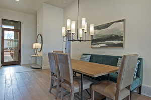 Dining space featuring light wood finished floors and a chandelier