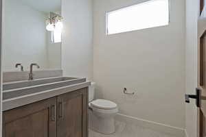 Bathroom with vanity and baseboards