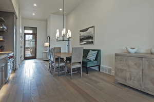 Dining space featuring light wood-style flooring, recessed lighting, and a chandelier