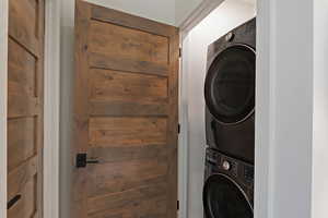 Washroom with stacked washer and clothes dryer
