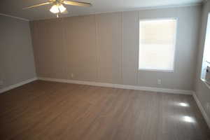 Spare room with wood finished floors and a ceiling fan