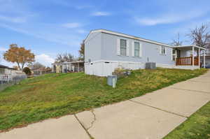 View of property exterior with a central AC unit