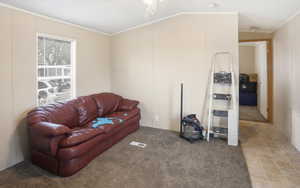 Living area featuring ornamental molding and carpet flooring