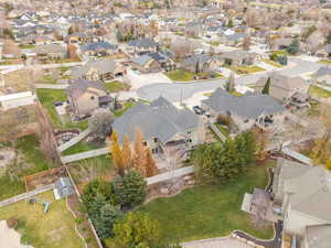 Aerial view of property and surrounding area with nearby suburban area