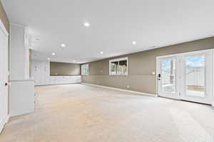 Spare room featuring recessed lighting and light colored carpet