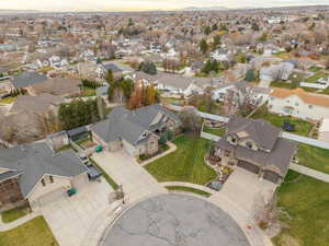Aerial view of property and surrounding area with nearby suburban area