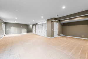 Below grade area with recessed lighting and light colored carpet