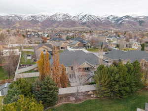 Aerial overview of property's location featuring a mountainous background and nearby suburban area