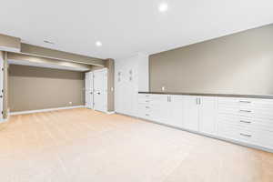 Spare room featuring light colored carpet and recessed lighting