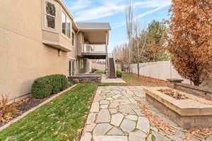 Patio / terrace with stairway, a fenced backyard, and a patio