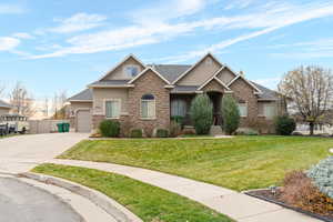 Craftsman inspired home featuring stone siding, stucco siding, concrete driveway, roof with shingles, and a garage