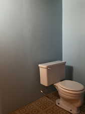 Half bath with toilet and enough room to add a sink