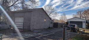 View of home's exterior featuring an outdoor structure and a detached garage