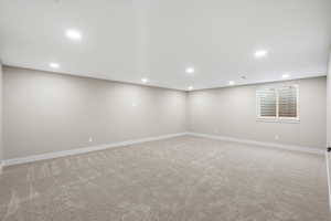 Basement with light colored carpet and recessed lighting
