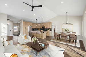 Living area featuring a chandelier, dark wood-style floors, lofted ceiling, ceiling fan, and recessed lighting