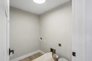 Laundry room featuring hookup for a washing machine, light wood-style flooring, and hookup for an electric dryer