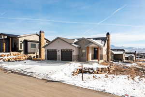 Modern farmhouse style home featuring a garage and a chimney