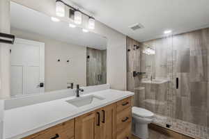 Full bath with a stall shower and vanity