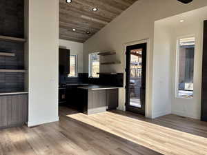 Kitchen with open shelves, vaulted ceiling, recessed lighting, wood ceiling, and plenty of natural light