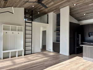 Kitchen with modern cabinets, wood ceiling, open shelves, light countertops, and a barn door