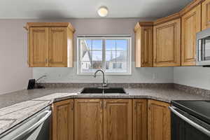 Kitchen featuring appliances with stainless steel finishes and brown cabinetry