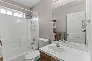 Full bathroom featuring shower / tub combo with curtain and vanity